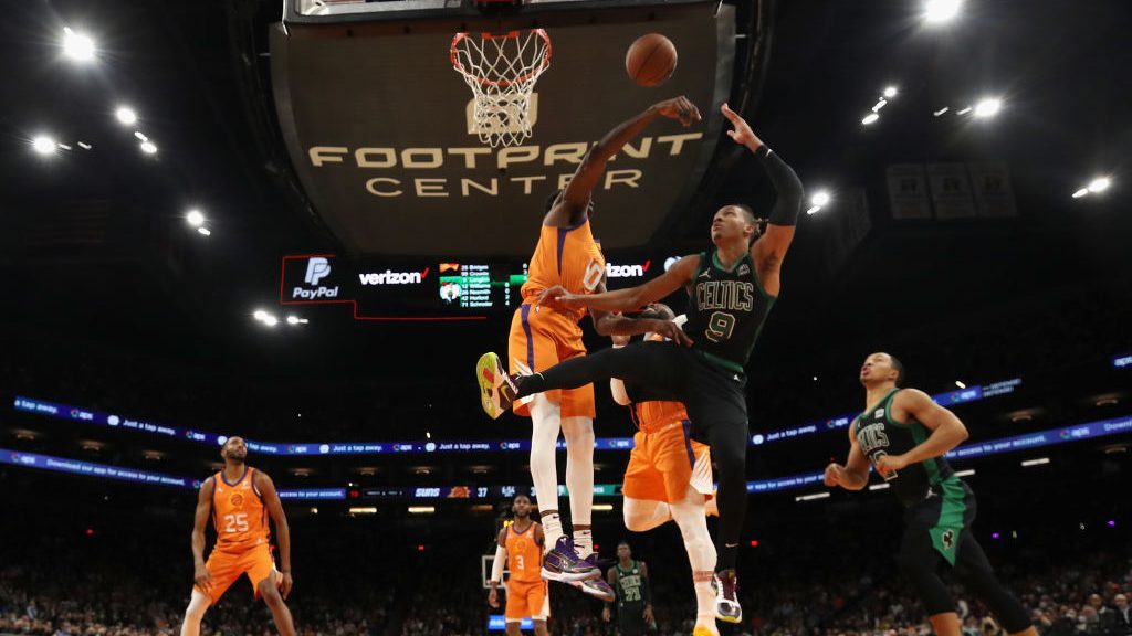 Romeo Langford #9 of the Boston Celtics has his shot blocked by Jalen Smith #10 of the Phoenix Suns...