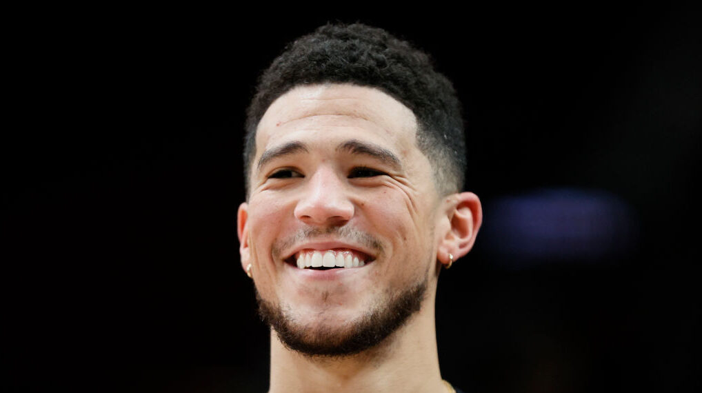Devin Booker #1 of the Phoenix Suns smiles before the game against the Portland Trail Blazers at Mo...
