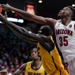 TUCSON, ARIZONA - DECEMBER 15: Center Christian Koloko #35 of the Arizona Wildcats and forward Kur Jongkuch #15 of the Northern Colorado Bears reach after a rebound during the second half at McKale Center on December 15, 2021 in Tucson, Arizona. The Arizona Wildcats won 101-76. (Photo by Rebecca Noble/Getty Images)