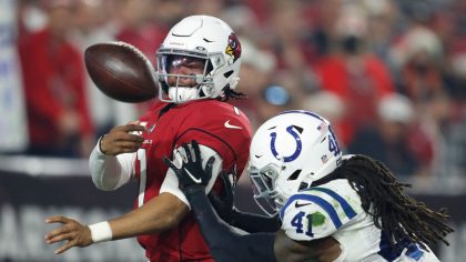 Kyler Murray #1 of the Arizona Cardinals throws a pass around Jahleel Addae #41 of the Indianapolis...