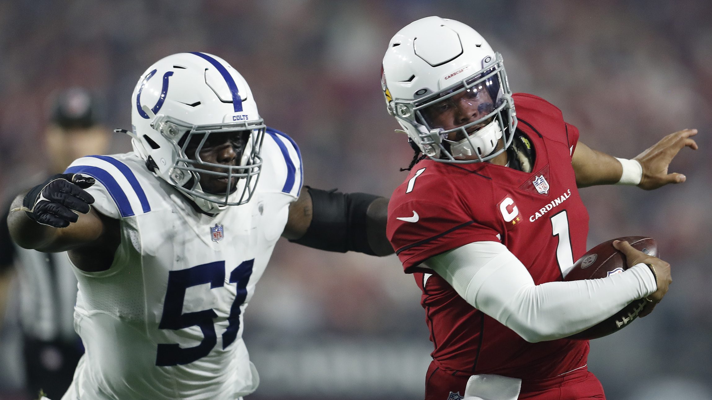 Kyler Murray #1 of the Arizona Cardinals scrambles away from Kwity Paye #51 of the Indianapolis Col...