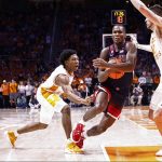 Arizona guard Bennedict Mathurin (0) drives as Tennessee forward John Fulkerson (10) and guard Kennedy Chandler (1) defends during an NCAA college basketball game Wednesday, Dec. 22, 2021, in Knoxville, Tenn. Tennessee won 77-73. (AP Photo/Wade Payne)