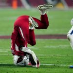 Arizona Cardinals running back Chase Edmonds falls after a hit against the Indianapolis Colts during the first half of an NFL football game, Saturday, Dec. 25, 2021, in Glendale, Ariz. (AP Photo/Ross D. Franklin)