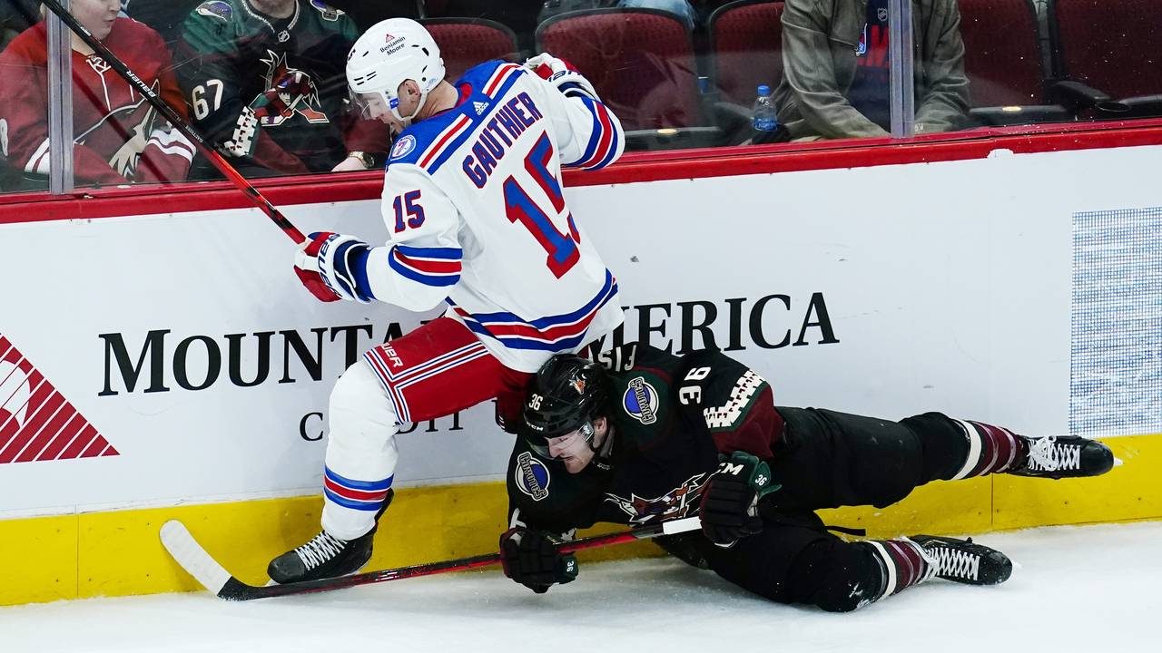 New York Rangers right wing Julien Gauthier (15) sends Arizona Coyotes right wing Christian Fischer...