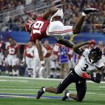 Alabama's Jahleel Billingsley (19) leaps over Cincinnati's Ja'von Hicks (3) during the first half of the Cotton Bowl NCAA College Football Playoff semifinal game, Friday, Dec. 31, 2021, in Arlington, Texas. (AP Photo/Michael Ainsworth)
