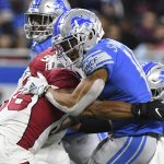 Detroit Lions wide receiver Amon-Ra St. Brown (14) is tackled by Arizona Cardinals outside linebacker Jordan Hicks (58) during the first half of an NFL football game, Sunday, Dec. 19, 2021, in Detroit. (AP Photo/Lon Horwedel)