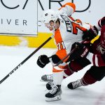Philadelphia Flyers center Max Willman (71) controls the puck as Arizona Coyotes right wing Clayton Keller (9) crashes into Willman during the first period of an NHL hockey game Saturday, Dec. 11, 2021, in Glendale, Ariz. (AP Photo/Ross D. Franklin)