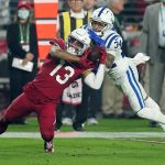 Arizona Cardinals wide receiver Christian Kirk (13) pulls in a catch as Indianapolis Colts cornerback Isaiah Rodgers (34) defends during the first half of an NFL football game, Saturday, Dec. 25, 2021, in Glendale, Ariz. (AP Photo/Ross D. Franklin)
