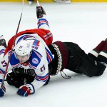 New York Rangers center Kevin Rooney (17) flips over Arizona Coyotes center Nick Schmaltz, right, during the first period of an NHL hockey game Wednesday, Dec. 15, 2021, in Glendale, Ariz. (AP Photo/Ross D. Franklin)