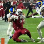 Arizona Cardinals running back James Conner (6) is pulled down by Los Angeles Rams inside linebacker Troy Reeder, left, and safety Jordan Fuller (4) during the first half of an NFL football game Monday, Dec. 13, 2021, in Glendale, Ariz. (AP Photo/Rick Scuteri)