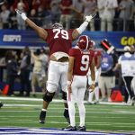 Alabama quarterback Bryce Young (9) celebrates with offensive lineman Chris Owens (79) after throwing a touchdown pass against Cincinnati during the first half of the Cotton Bowl NCAA College Football Playoff semifinal game, Friday, Dec. 31, 2021, in Arlington, Texas. (AP Photo/Michael Ainsworth)
