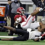 Alabama wide receiver Jameson Williams, top, is tackled by Cincinnati cornerback Ahmad Gardner during the first half of the Cotton Bowl NCAA College Football Playoff semifinal game, Friday, Dec. 31, 2021, in Arlington, Texas. (AP Photo/Michael Ainsworth)