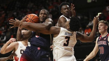 Arizona's Bennedict Mathurin (0) and Oregon State's Dexter Akanno (3) fight for a rebound during th...
