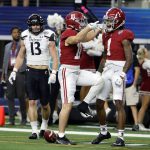 Alabama wide receiver Slade Bolden (18) celebrates with Jameson Williams (1) after catching a touchdown pass against Cincinnati during the first half of the Cotton Bowl NCAA College Football Playoff semifinal game, Friday, Dec. 31, 2021, in Arlington, Texas. (AP Photo/Michael Ainsworth)