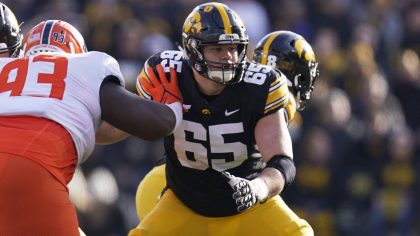 Iowa offensive lineman Tyler Linderbaum (65) looks to make a block during the first half of an NCAA...