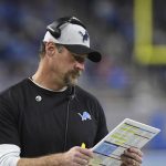 Detroit Lions head coach Dan Campbell looks over his play sheet during the first half of an NFL football game against the Arizona Cardinals, Sunday, Dec. 19, 2021, in Detroit. (AP Photo/Lon Horwedel)