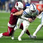 Arizona Cardinals defensive lineman Josh Mauro tackles Indianapolis Colts quarterback Carson Wentz (2) during the second half of an NFL football game, Saturday, Dec. 25, 2021, in Glendale, Ariz. (AP Photo/Ross D. Franklin)