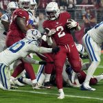 Arizona Cardinals running back Chase Edmonds (2) scores a touchdown as Indianapolis Colts safety George Odum (30) defends during the first half of an NFL football game, Saturday, Dec. 25, 2021, in Glendale, Ariz. (AP Photo/Rick Scuteri)