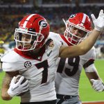 Georgia wide receiver Jermaine Burton (7) celebrates with tight end Brock Bowers (19) after a touchdown reception against Michigan during the second quarter of the NCAA College Football Playoff Orange Bowl game Friday, Dec. 31, 2021, in Miami Gardens, Fla. (Curtis Compton/Atlanta Journal-Constitution via AP)