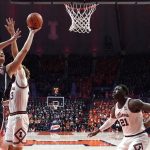 Arizona forward Azuolas Tubelis (10) scores over Illinois forward Coleman Hawkins (33) as center Kofi Cockburn watches during the first half of an NCAA college basketball game Saturday, Dec. 11, 2021, in Champaign, Ill. (AP Photo/Charles Rex Arbogast)