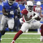 Arizona Cardinals running back Chase Edmonds (2) rushes as Detroit Lions outside linebacker Charles Harris (53) gives chase during the second half of an NFL football game, Sunday, Dec. 19, 2021, in Detroit. (AP Photo/Lon Horwedel)
