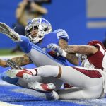 Detroit Lions wide receiver Josh Reynolds, defended by Arizona Cardinals cornerback Byron Murphy catches a 22-yard pass for a touchdown during the first half of an NFL football game, Sunday, Dec. 19, 2021, in Detroit. (AP Photo/Jose Juarez)