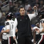 Cincinnati coach Luke Fickell watches his team warm up before the Cotton Bowl NCAA College Football Playoff semifinal game against Alabama, Friday, Dec. 31, 2021, in Arlington, Texas. (AP Photo/Jeffrey McWhorter)