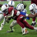 Arizona Cardinals running back Chase Edmonds (2) is tackled by Indianapolis Colts safety Jahleel Addae, (41), during the second half of an NFL football game, Saturday, Dec. 25, 2021, in Glendale, Ariz. (AP Photo/Rick Scuteri)