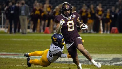 Minnesota running back Ky Thomas (8) gets away form West Virginia safety Saint McLeod during the se...