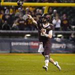 Minnesota quarterback Tanner Morgan throws a pass against West Virginia during the first half of the Guaranteed Rate Bowl NCAA college football game Tuesday, Dec. 28, 2021, in Phoenix. (AP Photo/Rick Scuteri)