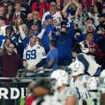 Indianapolis Colts fans cheer after a touchdown against the Arizona Cardinals during the second half of an NFL football game, Saturday, Dec. 25, 2021, in Glendale, Ariz. (AP Photo/Ross D. Franklin)