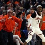 Illinois' Trent Frazier (1) celebrates with fans after his three-point basket during the first half of an NCAA college basketball game against Arizona, Saturday, Dec. 11, 2021, in Champaign, Ill. (AP Photo/Charles Rex Arbogast)
