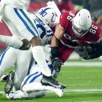 Arizona Cardinals tight end Zach Ertz (86) is hit by Indianapolis Colts safety George Odum (30) during the first half of an NFL football game, Saturday, Dec. 25, 2021, in Glendale, Ariz. (AP Photo/Ross D. Franklin)