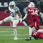 Indianapolis Colts running back Nyheim Hines (21) runs as Arizona Cardinals free safety Jalen Thompson (34) pursues during the first half of an NFL football game, Saturday, Dec. 25, 2021, in Glendale, Ariz. (AP Photo/Ross D. Franklin)