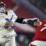 Los Angeles Rams defensive end Aaron Donald (99) is blocked by Arizona Cardinals guard Max Garcia (73) during the first half of an NFL football game Monday, Dec. 13, 2021, in Glendale, Ariz. (AP Photo/Ralph Freso)