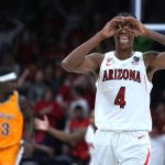 Arizona guard Dalen Terry (4) reacts after scoring against Wyoming during the first half of an NCAA college basketball game Wednesday, Dec. 8, 2021, in Tucson, Ariz. (AP Photo/Rick Scuteri)