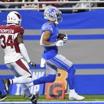 Detroit Lions wide receiver Amon-Ra St. Brown (14) runs into the end zone for a touchdown on a 37-yard reception during the first half of an NFL football game against the Arizona Cardinals, Sunday, Dec. 19, 2021, in Detroit. (AP Photo/Lon Horwedel)