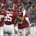 Alabama kicker Will Reichard (16) is congratulated by Kendall Randolph (85) after kicking a field goal against Cincinnati during the first half of the Cotton Bowl NCAA College Football Playoff semifinal game, Friday, Dec. 31, 2021, in Arlington, Texas. (AP Photo/Michael Ainsworth)