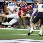Alabama wide receiver Slade Bolden (18) dives into the end zone for a touchdown after catching a pass as Cincinnati linebacker Ty Van Fossen (13) defends during the first half of the Cotton Bowl NCAA College Football Playoff semifinal game, Friday, Dec. 31, 2021, in Arlington, Texas. (AP Photo/Michael Ainsworth)