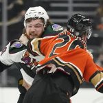 Arizona Coyotes center Liam O'Brien (38) and Anaheim Ducks left wing Nicolas Deslauriers (20) fight during the first period of an NHL hockey game in Anaheim, Calif., Friday, Dec. 17, 2021. (AP Photo/Ashley Landis)