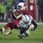 Arizona Cardinals running back Chase Edmonds is hit by Indianapolis Colts safety Jahleel Addae, right, during the second half of an NFL football game, Saturday, Dec. 25, 2021, in Glendale, Ariz. (AP Photo/Rick Scuteri)