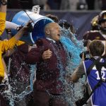 Minnesota head coach P.J. Fleck reacts after being doused during at the end of the team's Guaranteed Rate Bowl NCAA college football game against West Virginia on Tuesday, Dec. 28, 2021, in Phoenix. Minnesota won 18-6. (AP Photo/Rick Scuteri)