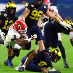 Georgia running back Zamir White (3) plows through defenders for a first down against Michigan during the third quarter of the NCAA College Football Playoff Orange Bowl game Friday, Dec. 31, 2021, in Miami Gardens, Fla. (Curtis Compton/Atlanta Journal-Constitution via AP)