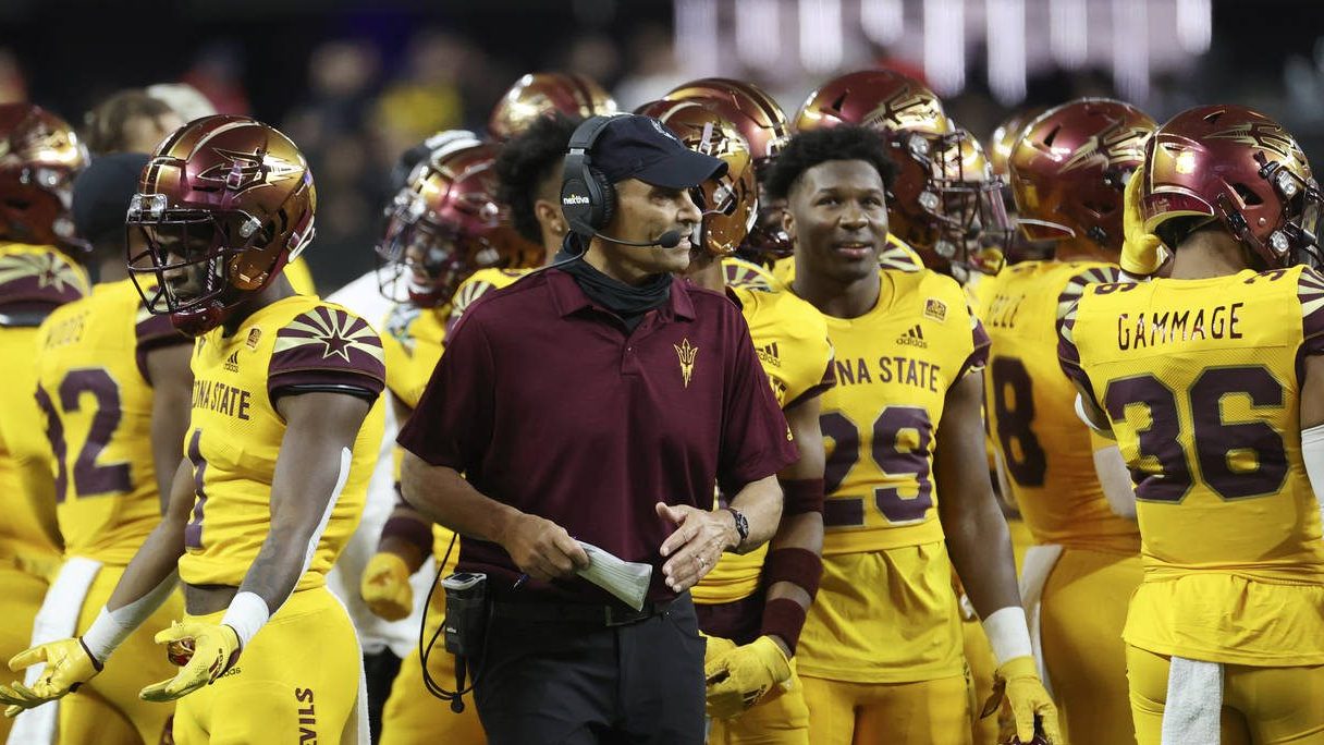 Arizona State head coach Herm Edwards speaks with his players during the first half of the Las Vega...