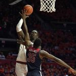 Illinois' Kofi Cockburn scores over Arizona's Christian Koloko (35) during the first half of an NCAA college basketball game Saturday, Dec. 11, 2021, in Champaign, Ill. (AP Photo/Charles Rex Arbogast)