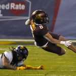 West Virginia cornerback Daryl Porter Jr. sends Minnesota running back Ky Thomas (8) to the turf during the first half of the Guaranteed Rate Bowl NCAA college football game Tuesday, Dec. 28, 2021, in Phoenix. (AP Photo/Rick Scuteri)