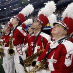 Alabama band members look up at the scoreboard before performing before the start of the Cotton Bowl NCAA College Football Playoff semifinal game against Cincinnati, Friday, Dec. 31, 2021, in Arlington, Texas. (AP Photo/Michael Ainsworth)