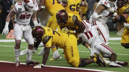 Arizona State running back Daniyel Ngata (4) scores a touchdown against Wisconsin during the second...