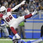 Arizona Cardinals tight end Zach Ertz (86) is tripped up by Detroit Lions cornerback AJ Parker (41) during the second half of an NFL football game, Sunday, Dec. 19, 2021, in Detroit. (AP Photo/Lon Horwedel)