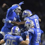 Teammates congratulate Detroit Lions wide receiver Josh Reynolds (8) after his touchdown during the first half of an NFL football game against the Arizona Cardinals, Sunday, Dec. 19, 2021, in Detroit. (AP Photo/Lon Horwedel)